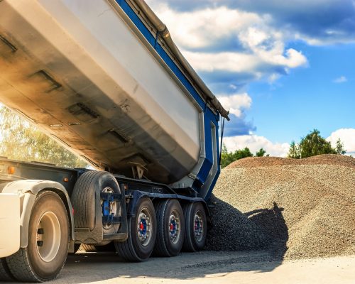A,Large,Dump,Truck,Unloads,Rubble,Or,Gravel,At,A